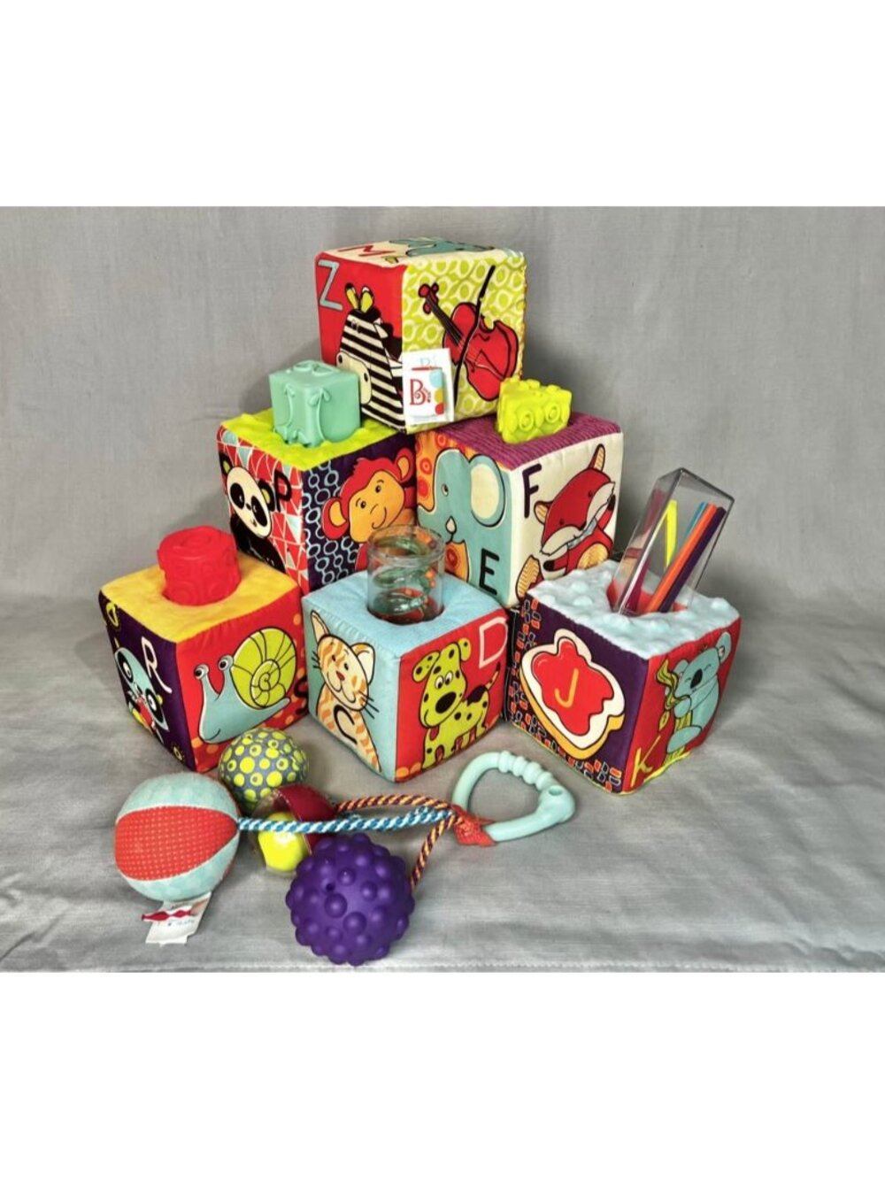 B. toys Soft Building Blocks & Sensory Rattle